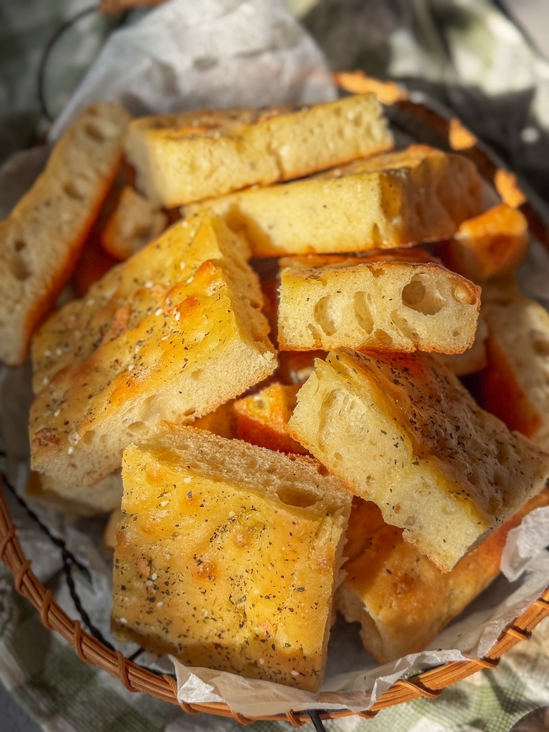 Thick and fluffy Olive Oil Flatbread with Herbs, garlic, flaky salt, and golden edges.