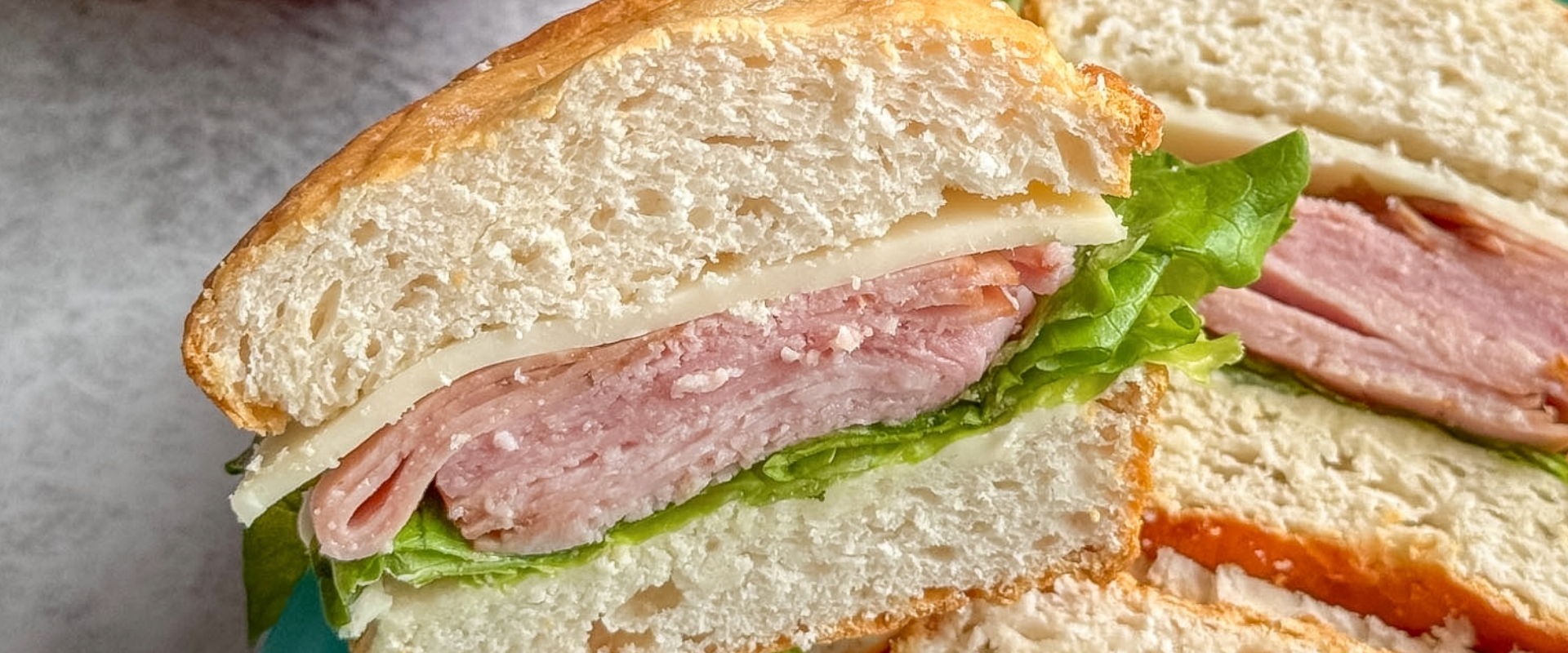 Kid-friendly school lunchbox with deli sandwich and fresh vegetables