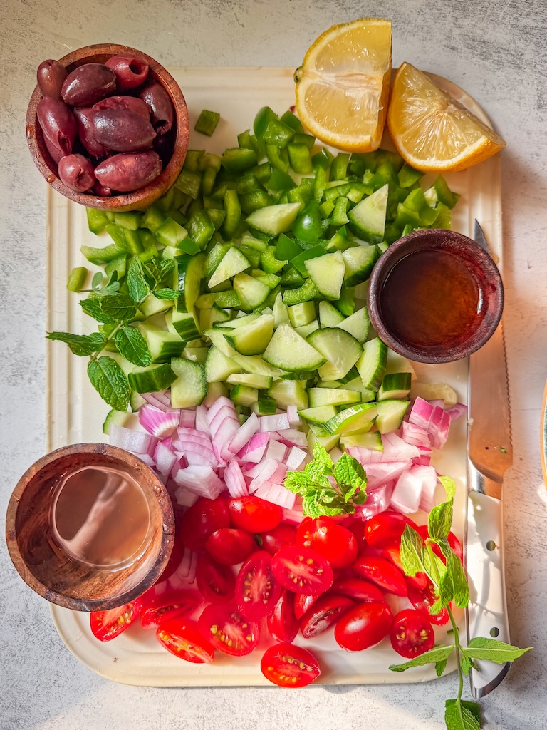 Fresh Greek-inspired pasta salad made with bow tie pasta, cucumbers, tomatoes, feta, olives, and homemade lemon dressing.