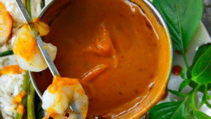Creamy Thai Peanut Dipping Sauce made with coconut milk, lime, and red curry paste. Perfect with shrimp, veggies, or noodles. Ready in minutes!