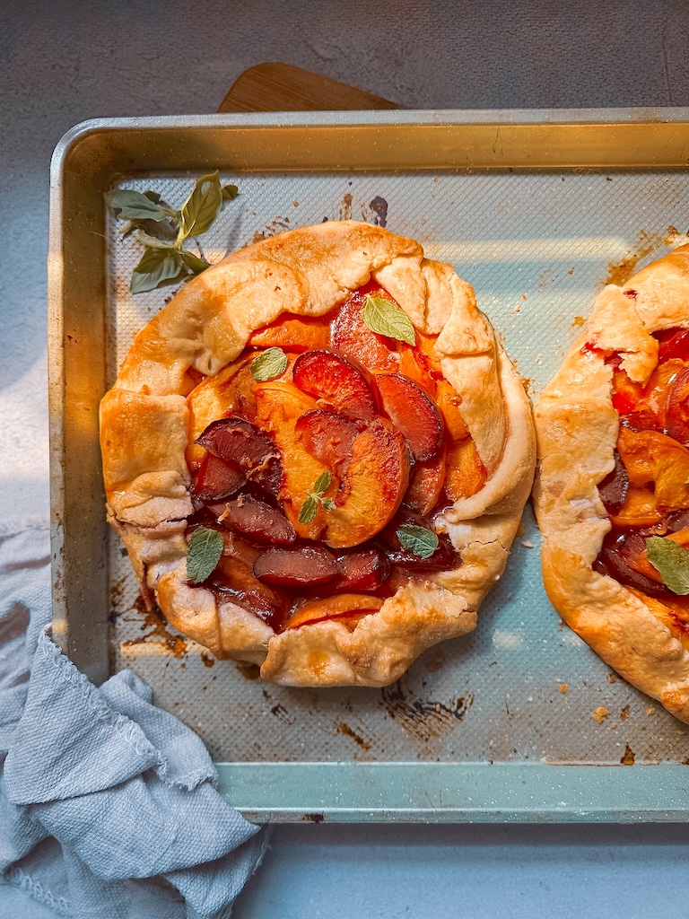 Bake this easy Plum and Peach Galette with a flaky homemade butter crust. Made with fresh peaches and plums, it's the perfect rustic summer dessert.