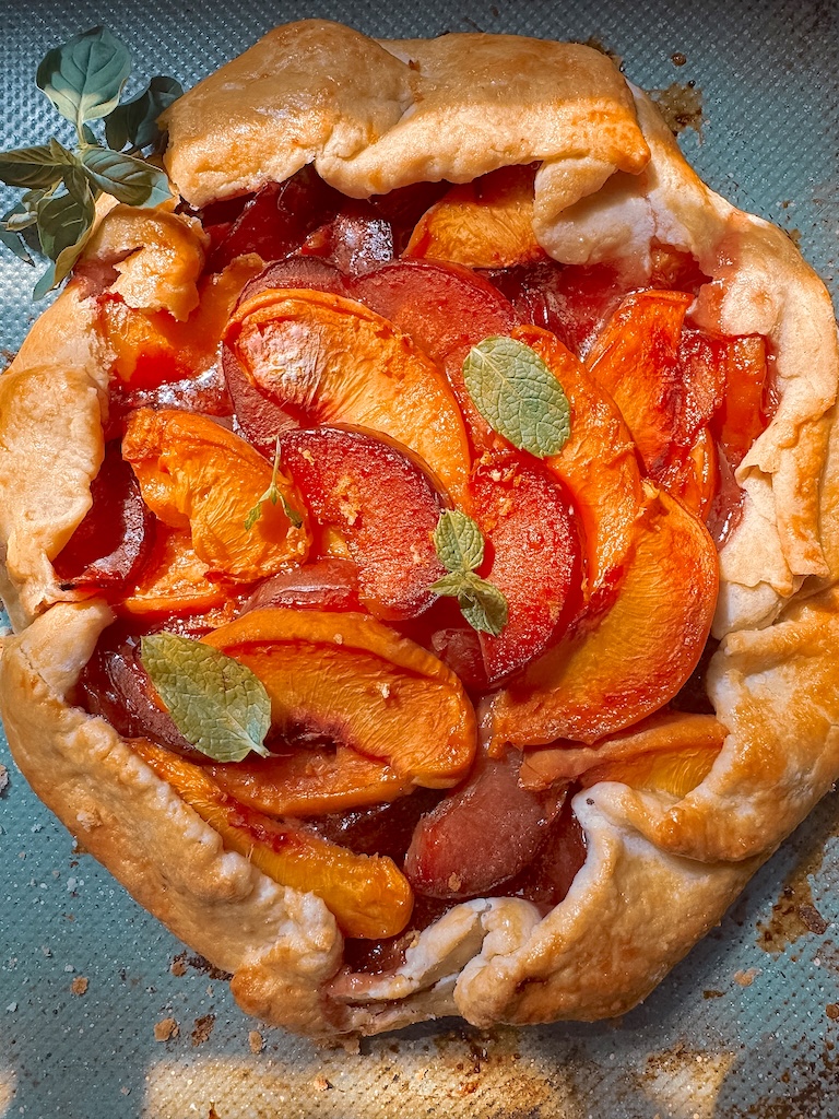 Bake this easy Plum and Peach Galette with a flaky homemade butter crust. Made with fresh peaches and plums, it's the perfect rustic summer dessert.