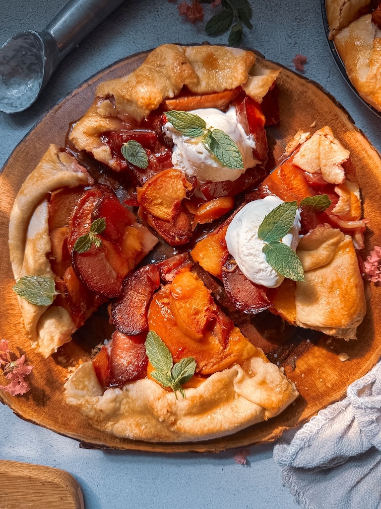 Bake this easy Plum and Peach Galette with a flaky homemade butter crust. Made with fresh peaches and plums, it's the perfect rustic summer dessert.