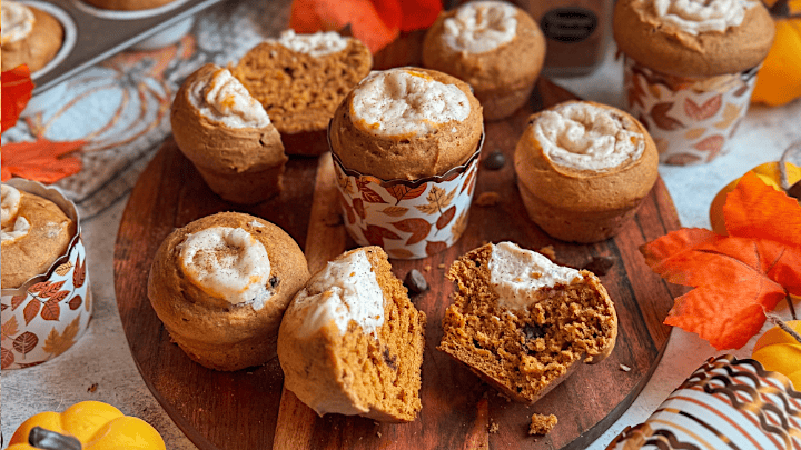 Pumpkin cream cheese muffins with chocolate chips on wooden board – fall baking recipe inspired by Starbucks pumpkin muffin.
