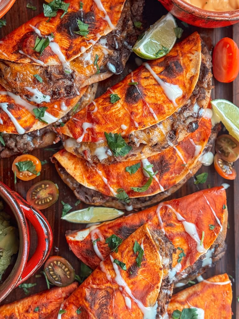 Baked beef and bean soft tacos with melted cheese and taco sauce