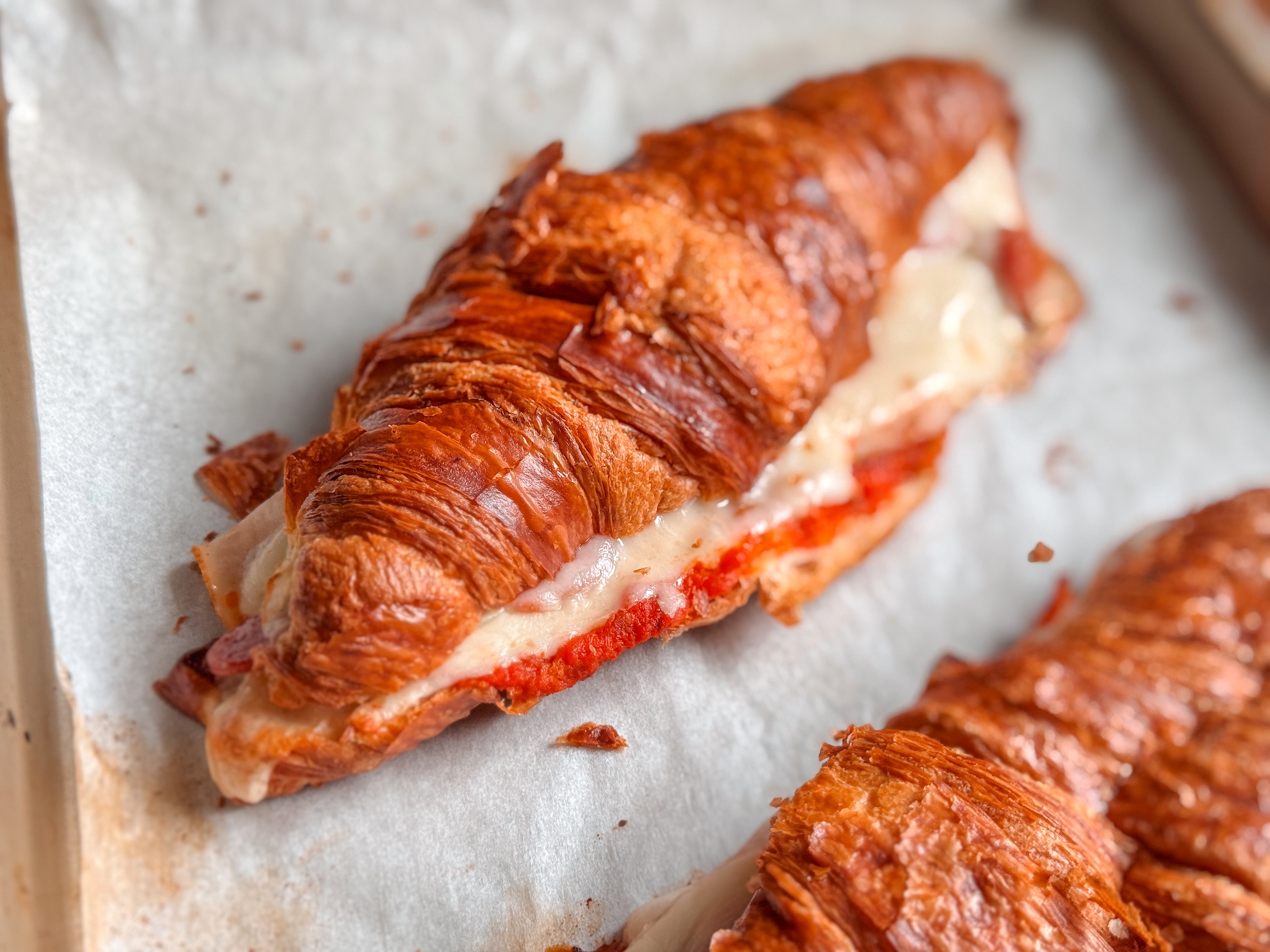 Pizza croissant sandwich made with leftover Costco croissants, mozzarella cheese, smoked turkey, pepperoni, and marinara sauce.